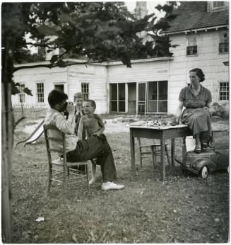 Mother and father playing in backyard with children