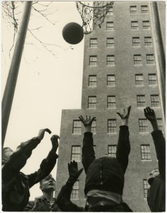 New York City boy playing basketball with friends