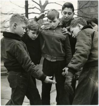 New York City boy playing ball with friends