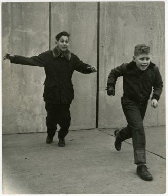 New York City boy playing with friend in empty court