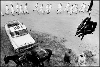 Guns are passed to the picket tower; the line returns from work, Ferguson Unit, Texas from the series Conversations with the Dead