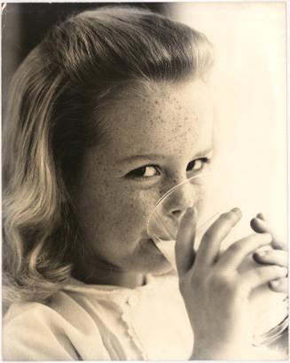 Portrait of girl drinking glass of milk