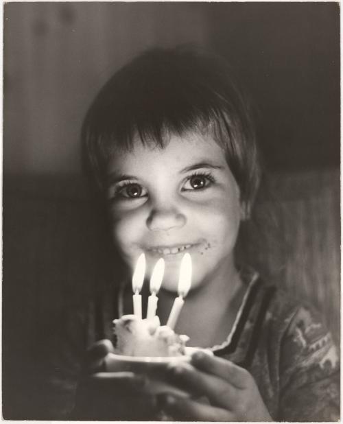 Portrait of girl with birthday cupcake