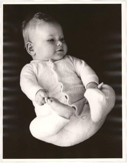 Portrait of baby playing with feet