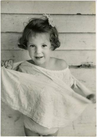 Portrait of a young girl playing with her dress