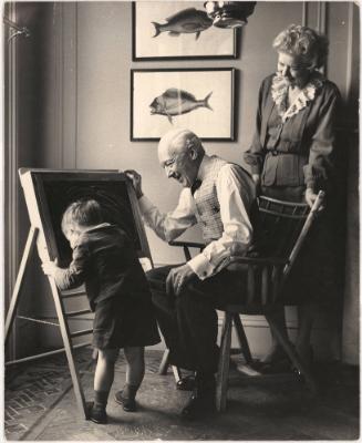 Elderly couple playing with grandson