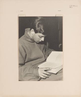 Boy in stylish coat reading