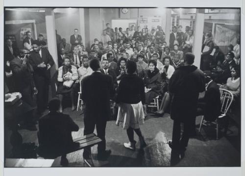 Nashville, Tennessee, additional photograph from the series Memories of the Southern Civil Rights Movement Bernice Reagon and the Freedom Singers lead a mass meeting of SNCC workers and student supporters. SNCC Chairman Chuck McDew stands with SNCC Executive Secretary James Forman on the left. Many of the earliest members and supporters of the SNCC appear in this picture.