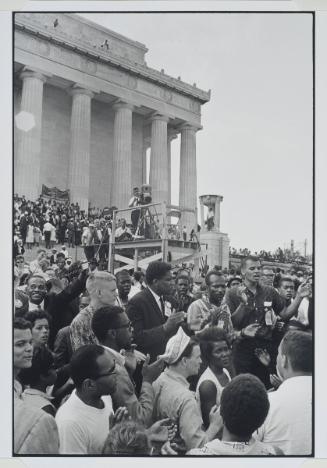 The March on Washington, additional photograph from the series Memories of the Southern Civil Rights Movement SNCC staff and friends gather after the March to defiantly sing freedom songs, which were prohibited during the March. Julian Bond, Elanor Holmes, Bob Moses, Courtland Cox, James Forman, Annell Ponder, Willie Peacock, and Curtis Hays appear in this picture.