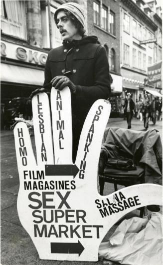 Man with Hands on Sign for “Sex Super Market,” Denmark