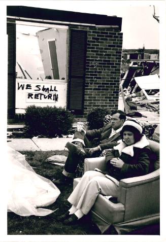 [People sitting outside business destroyed by tornado, Xenia, OH, USA]