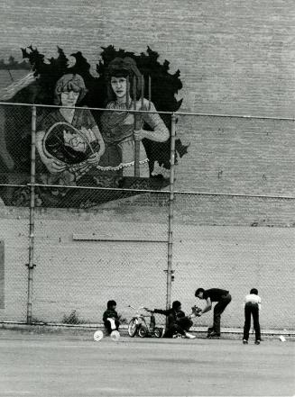 [Children in yard, mural on brick wall]