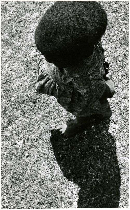 Little girl in the shadow of Mt. Kenya is exaggerated by camera’s wide lens, Kenya