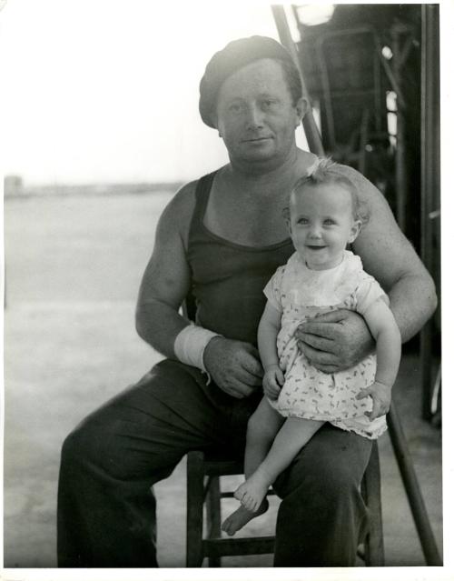 [Portrait of father with young girl on his lap]