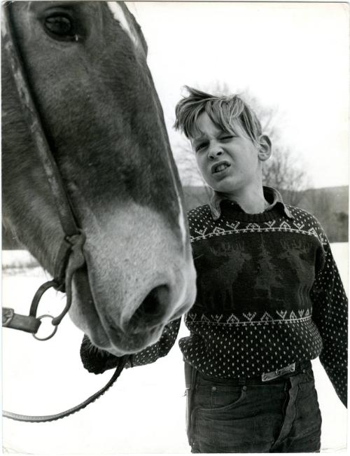 [Farm boy with horse in snow]