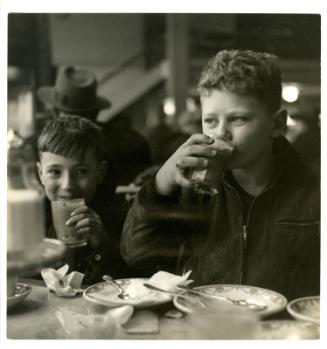 [NYC boy drinking with friend at restaurant]