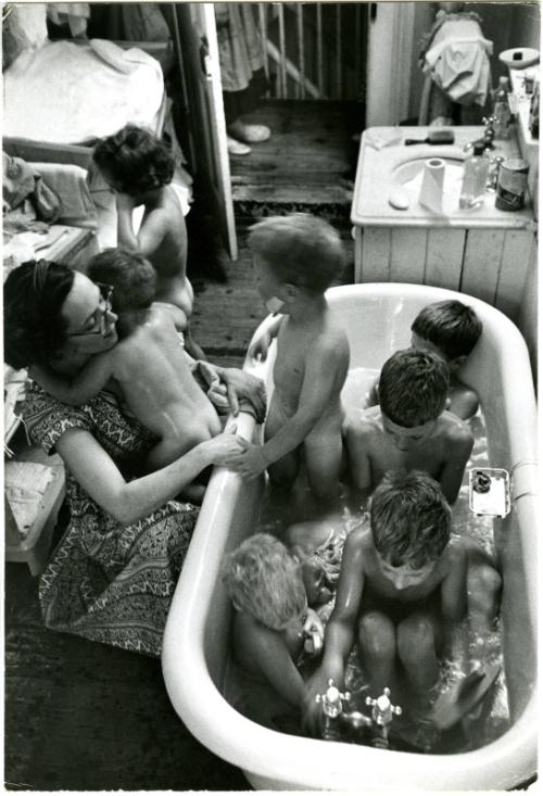 [Mother bathing seven children]