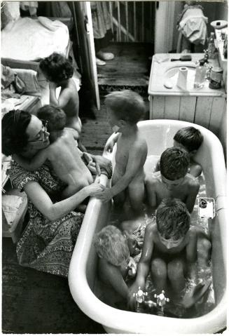 [Mother bathing seven children]