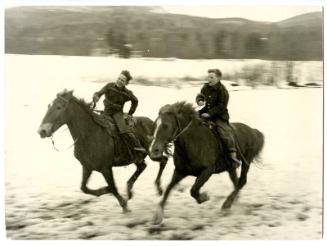 [Two boys riding horses]