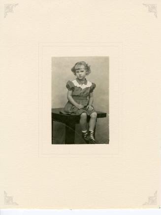 Rachel Prince, 4 yr. 8 mos [Girl seated on table]