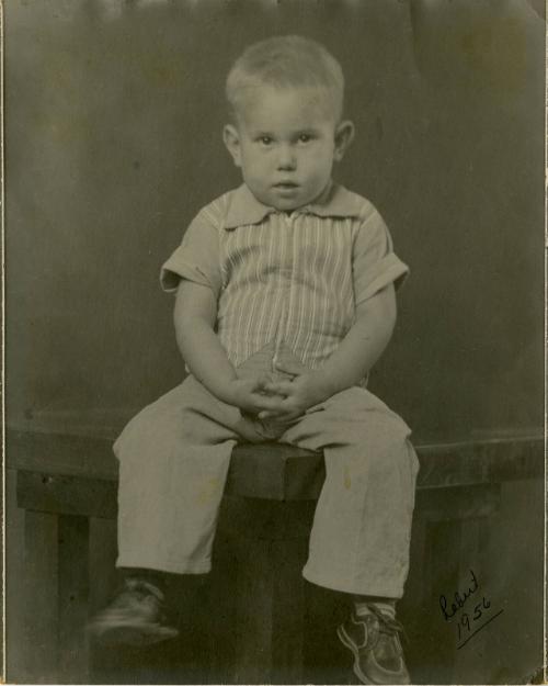 Robert [Boy in striped shirt seated on table]