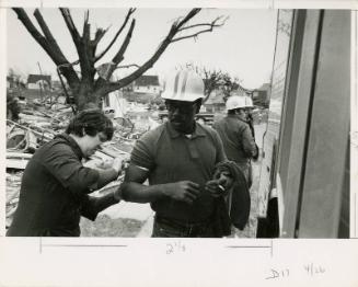 Worker receiving medical care outside homes damaged by tornado, Xenia, OH, USA