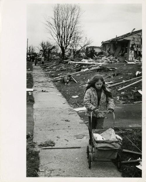 [Girl pushes cart outside homes damaged by tornado, Xenia, OH, USA]