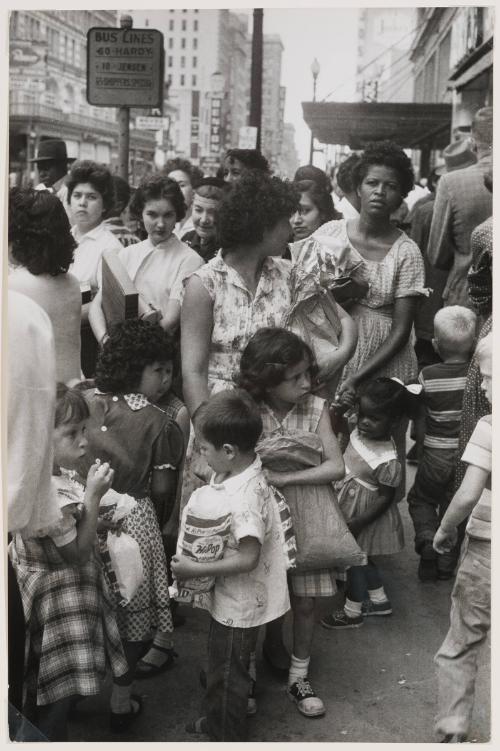 Crowded city sidewalk full of women with their children, USA