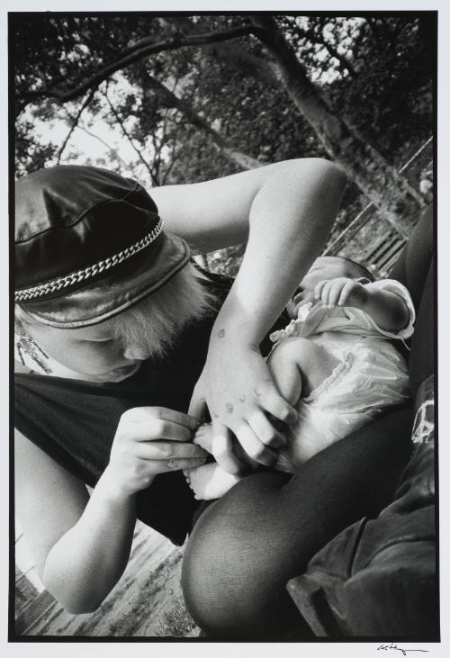 Punk girl cutting baby’s toenails, New York
