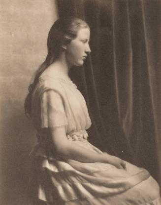 Portrait of young woman in profile, long braid down back