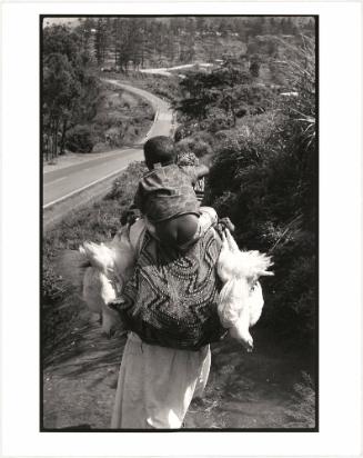 Little boy riding on parent’s back, Papua New Guinea