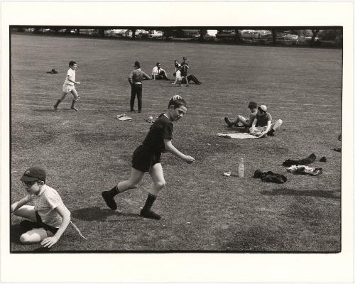 Teacher and students on athletic field, London