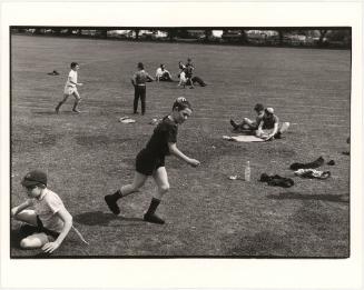 Teacher and students on athletic field, London