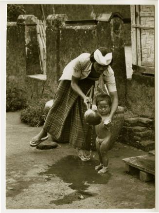 Bali [Woman washing child]