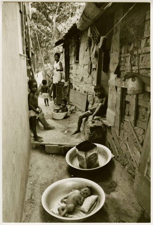 A baby in a basin in a favela, Rio de Janeiro, Brazil