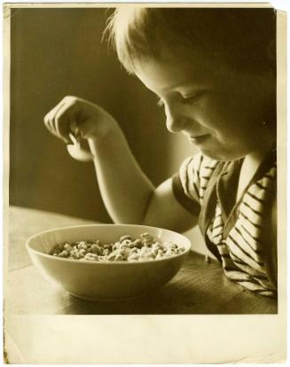 Portrait of young boy eating cereal