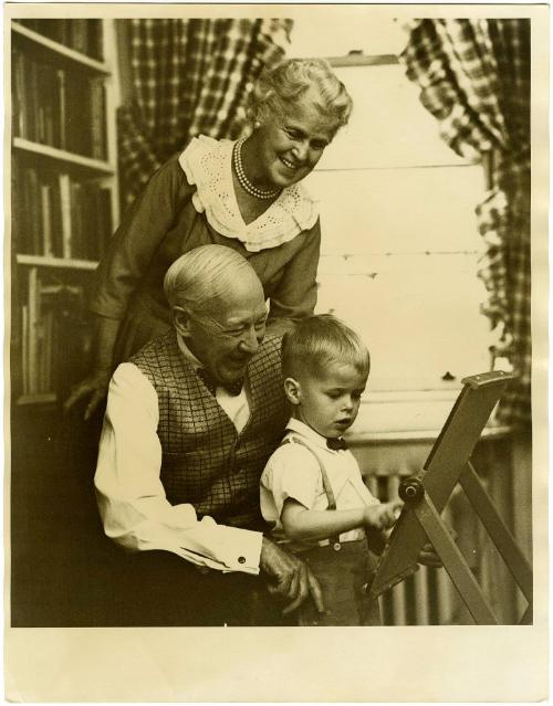 Elderly couple playing with grandson