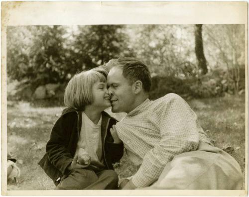 Portrait of father and young daughter laughing and embracing