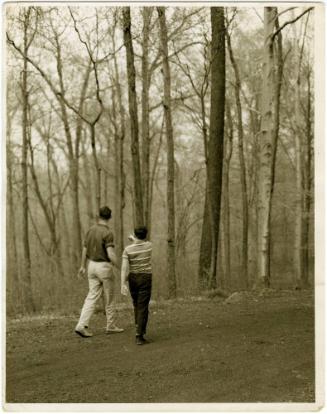 Father and boy with glasses walking in woods, from the series Big Brother