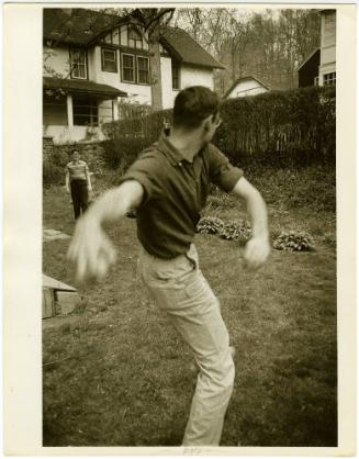 Boy with glasses and father playing catch in backyard, from the series Big Brother