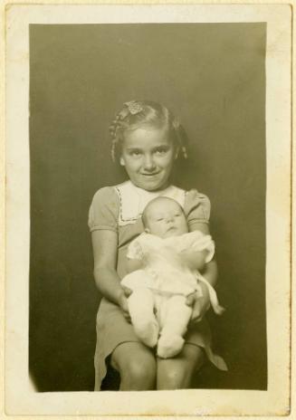 Wilma Jean and Rachel Linda Gay Prince [Smiling girl with bow in hair holding infant]