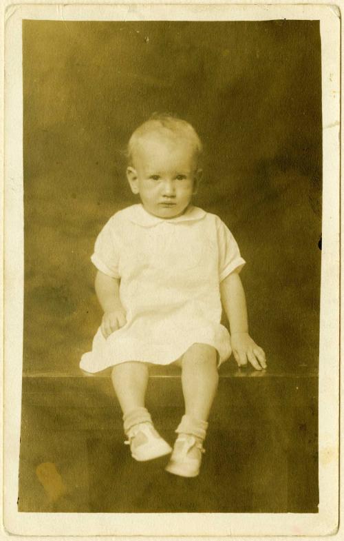 Infant seated on table