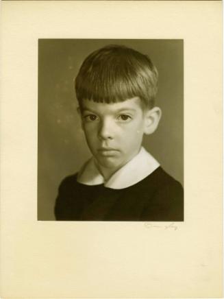 Portrait of boy wearing a white collared shirt