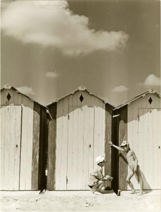 Two boys talking by shacks, Italy