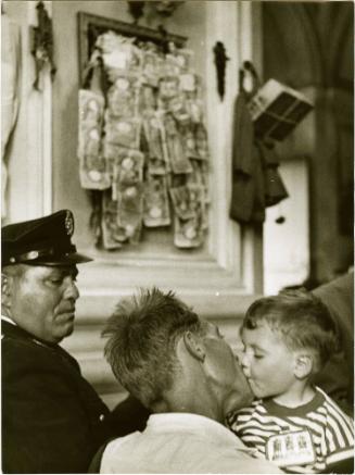 Man Kissing a Child Next to Policeman