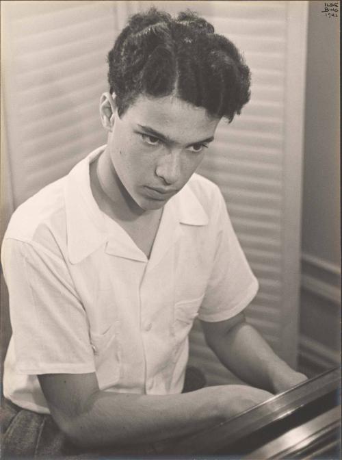 Young man at the piano, looking up