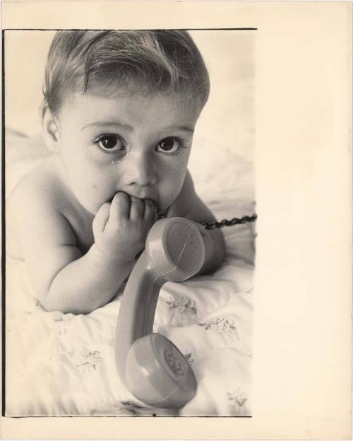 Portrait of baby playing with toy telephone