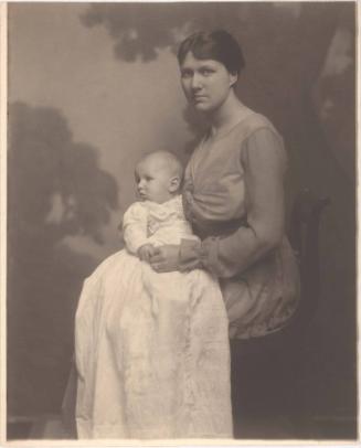 Portrait of mother, seated holding baby