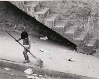 Semi-naked child sweeping, Venezuela