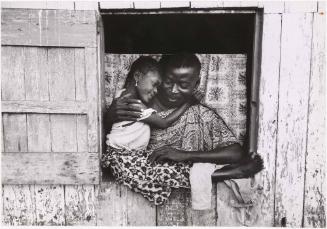 Father hugging daughter in a window frame